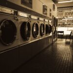 Sepia-toned image of a laundromat interior showcasing a row of classic washing machines.